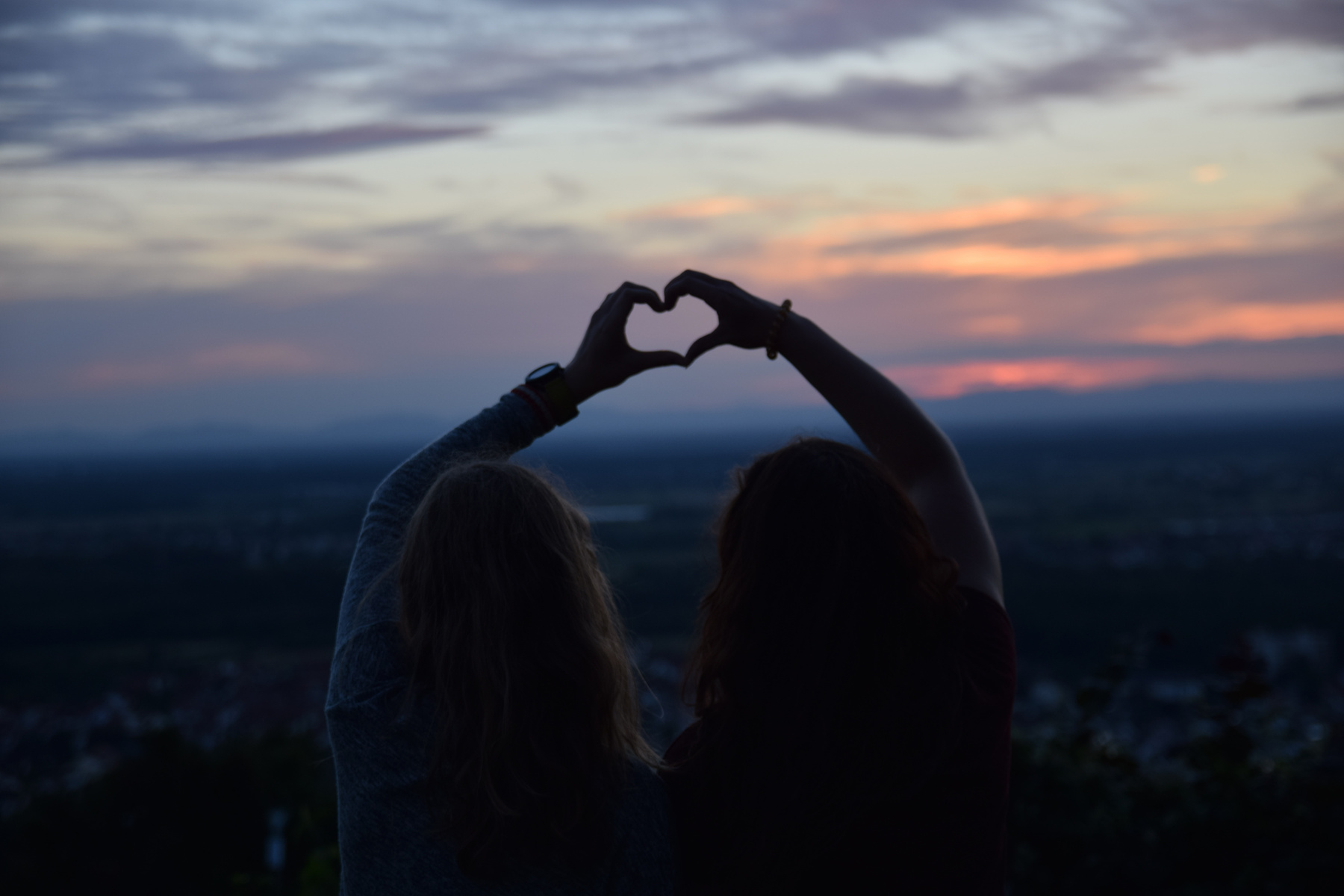 Friends Forming a Heart with Hands